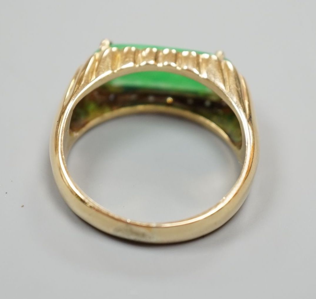 A yellow metal, jadeite and diamond set ovoid dress ring, size T, gross 6.6 grams.